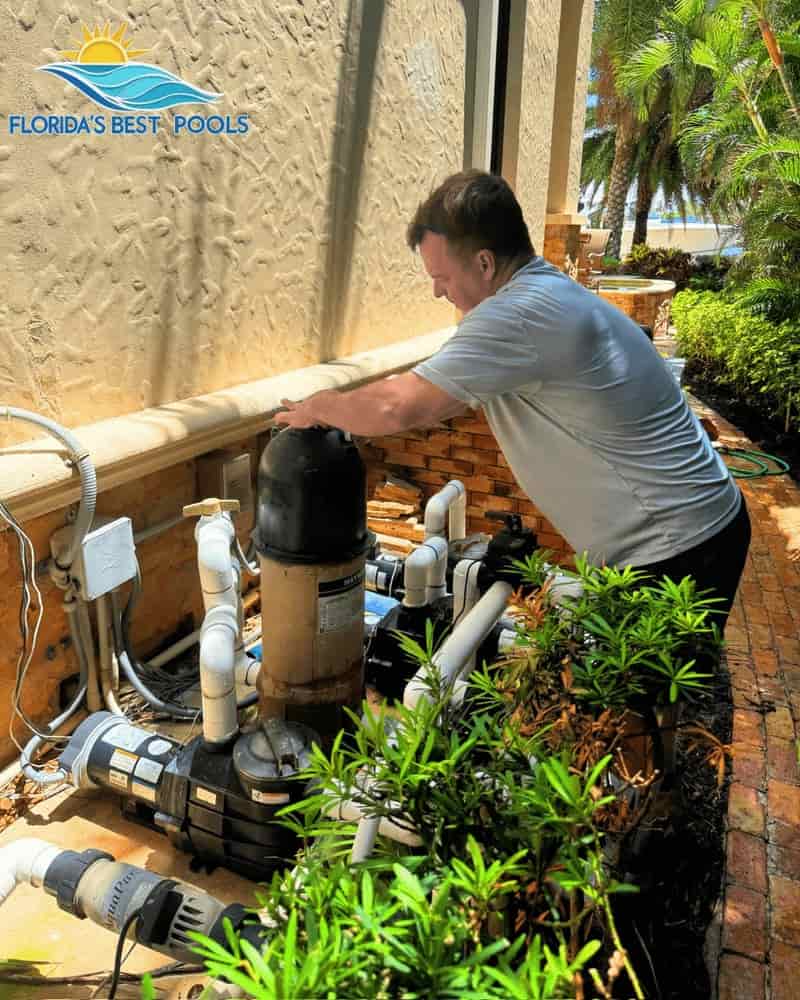 Technician inspecting pool equipment