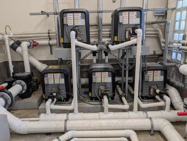 Commercial pool equipment room with pumps and filtration