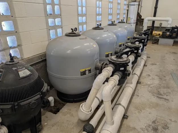 Florida's Best Pools technician loading the chlorine and acid crocs at a South Florida community pool equipment pad