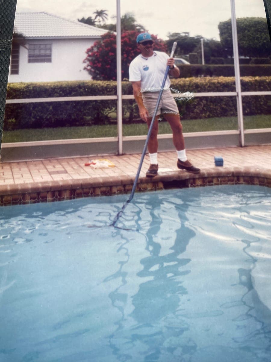 Jeffrey F. Balog skimming a screened South Florida pool during the original family company he founded in 1989