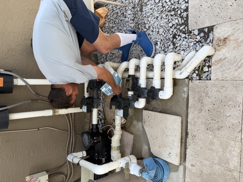 Pressure-testing pool plumbing and isolating equipment-pad valves during a pre-purchase pool inspection in South Florida — the suction and return lines a standard home inspection never touches